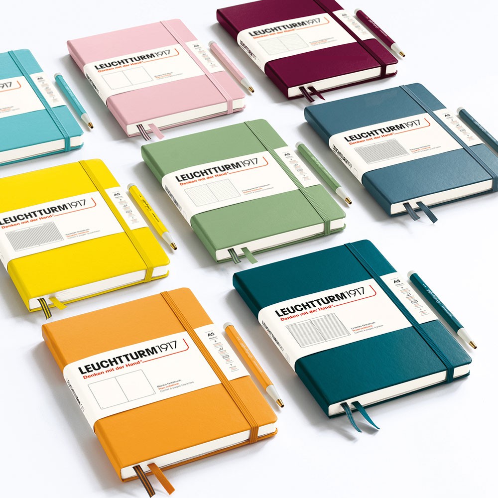 Leuchtturm1917 Medium Notebook A5 selection of colours lined up with matching pens on a white background.