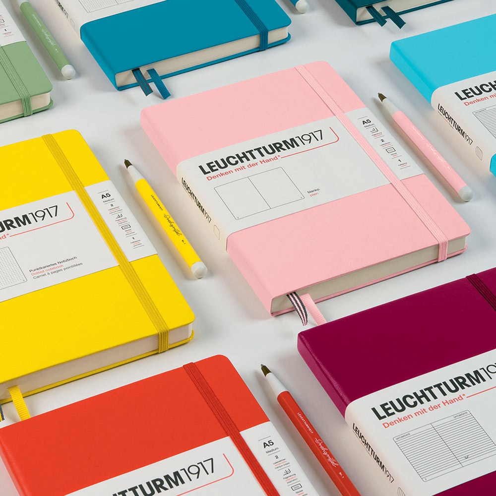 Leuchtturm1917 Medium Notebook A5 Close up of a range of hardback notebooks, their colours and matching pens