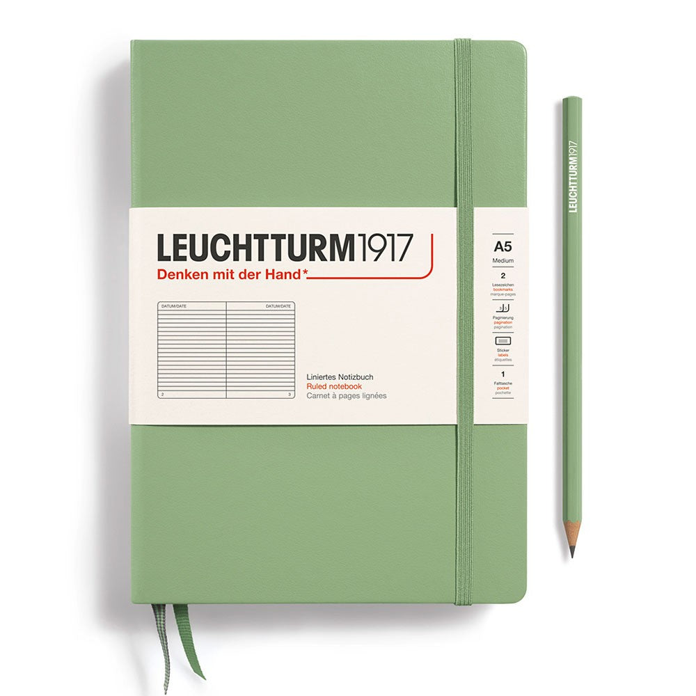 Leuchtturm1917 A5 Ruled Hardcover Notebook - Sage selection of colours lined up with matching pens on a white background.