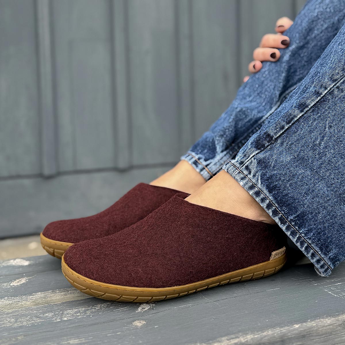 Woman wears Glerups rubber sole mule in beet