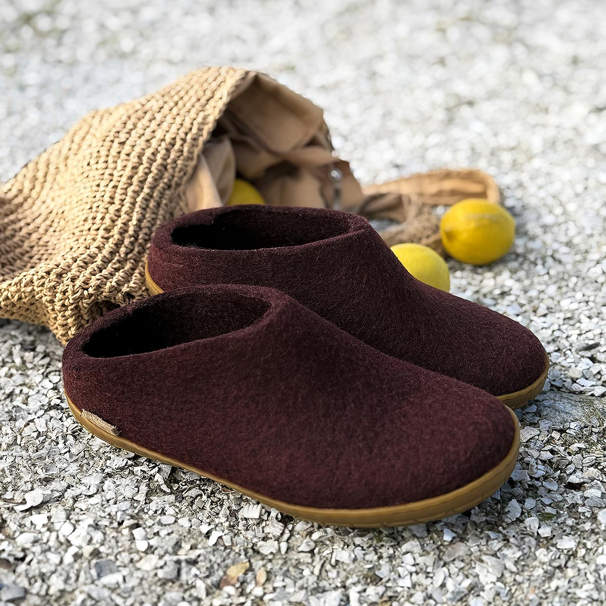 Beet Glerups mules with rubber soles lay outside on gravel