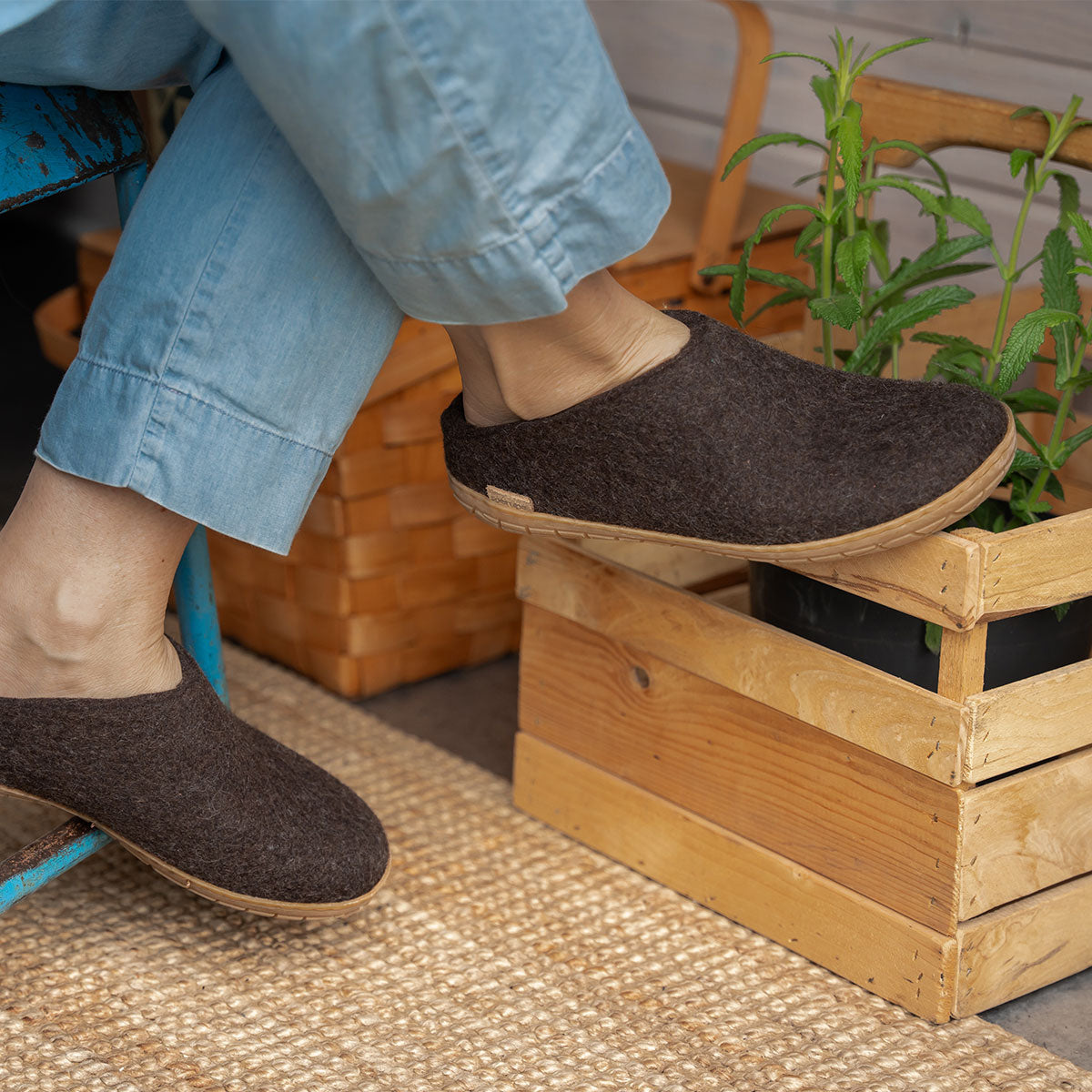 A woman wears rubber soled brown Glerups in mule style