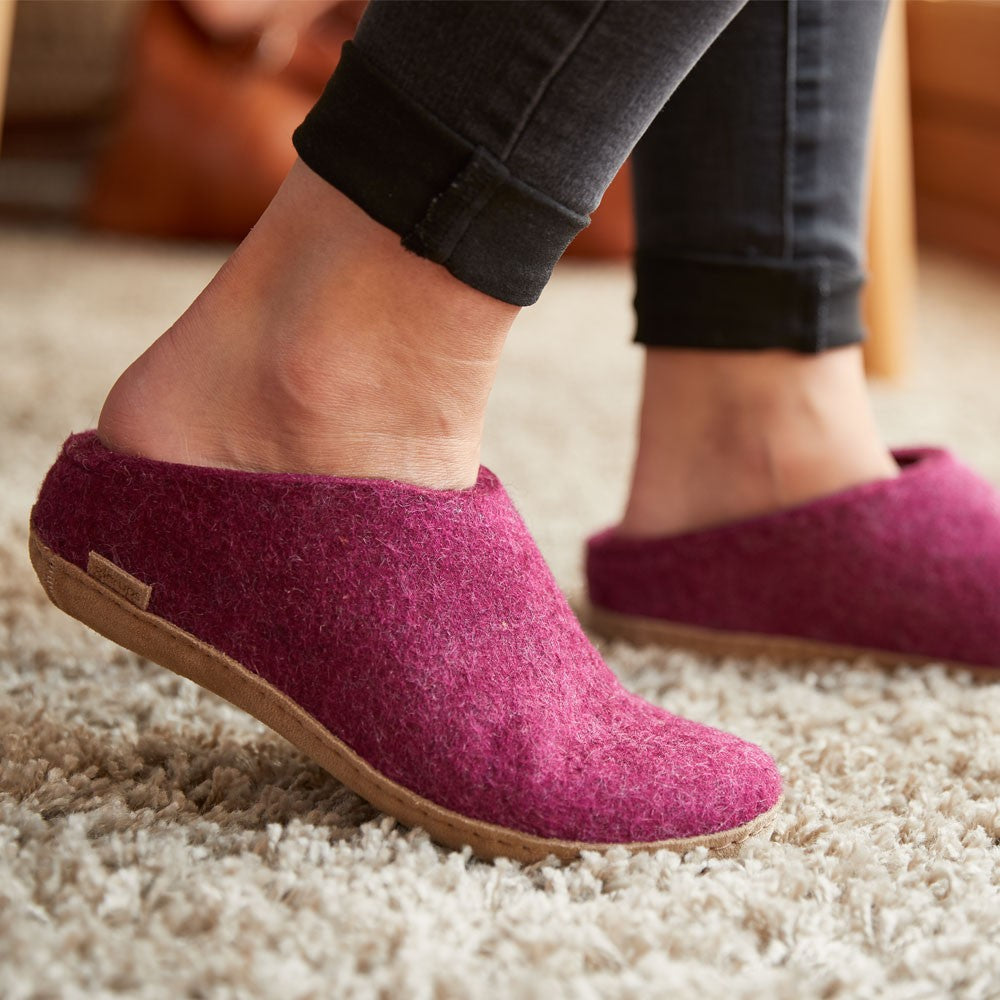 A woman wears a pair of Cranberry Glerups Mules with a Leather Sole