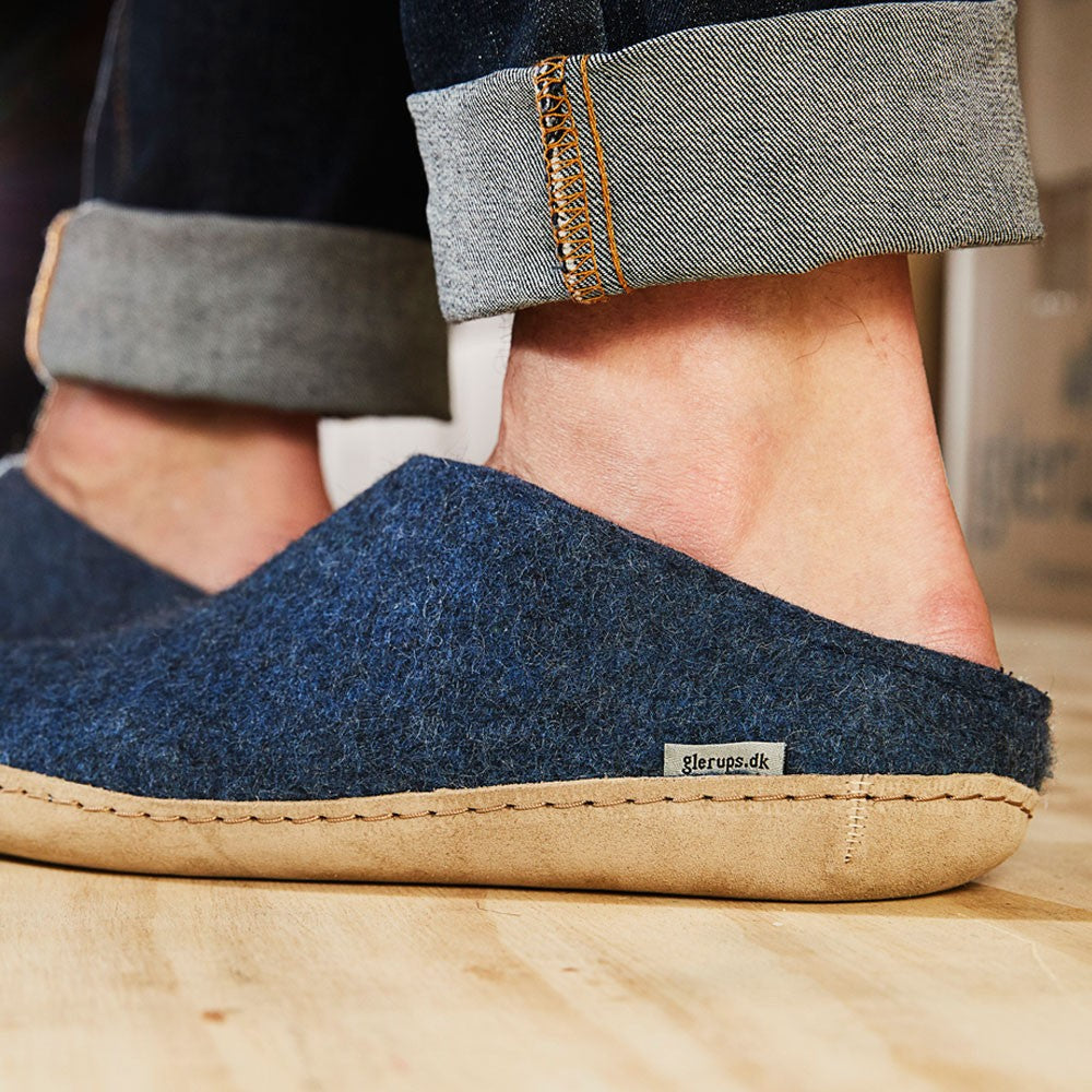Man wears denim leather soled Glerups mules in denim