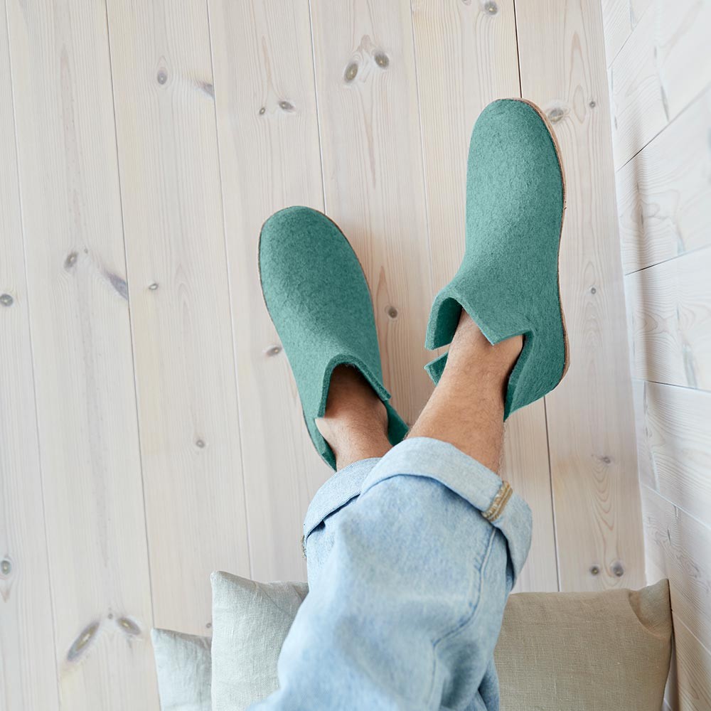 A man wears a pair of glerups boots with natural leather soles in North Sea