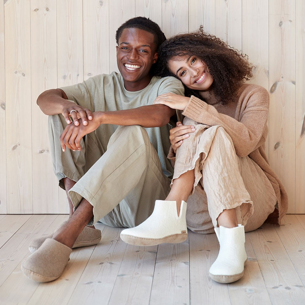 A couple wear Glerups together. The woman wears a pair of soft soled White boots