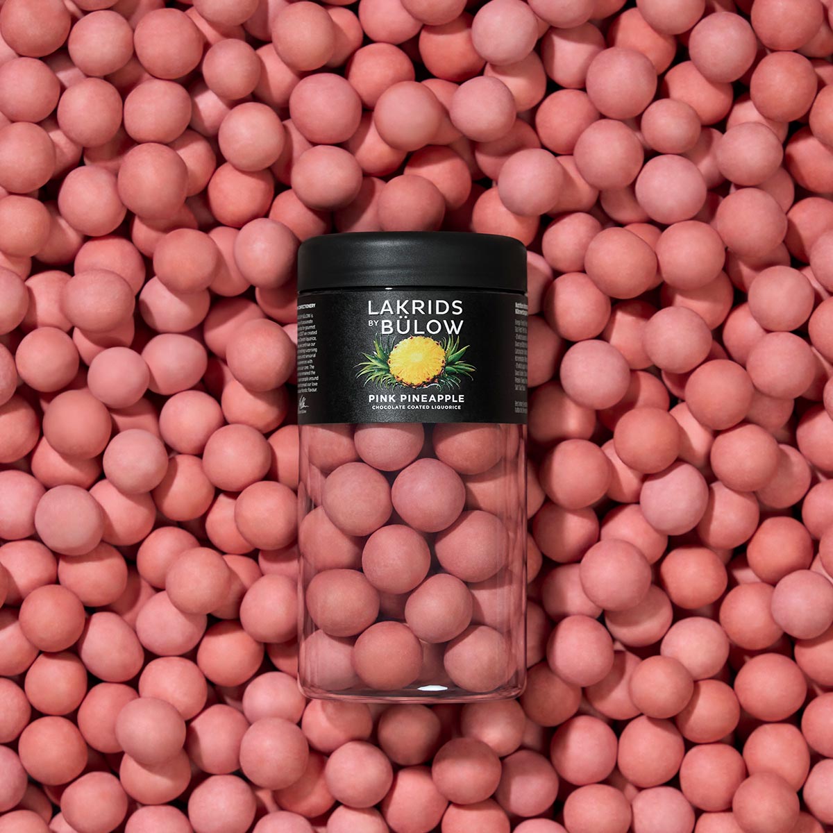 Lakrids Bülow pink pineapple candy jar on a bed of pink candies