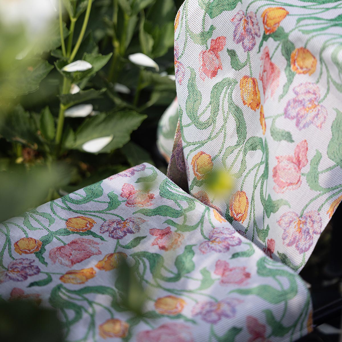 Ekelund 'Sonja' hand towel draped on a chair outside with greenery in the background