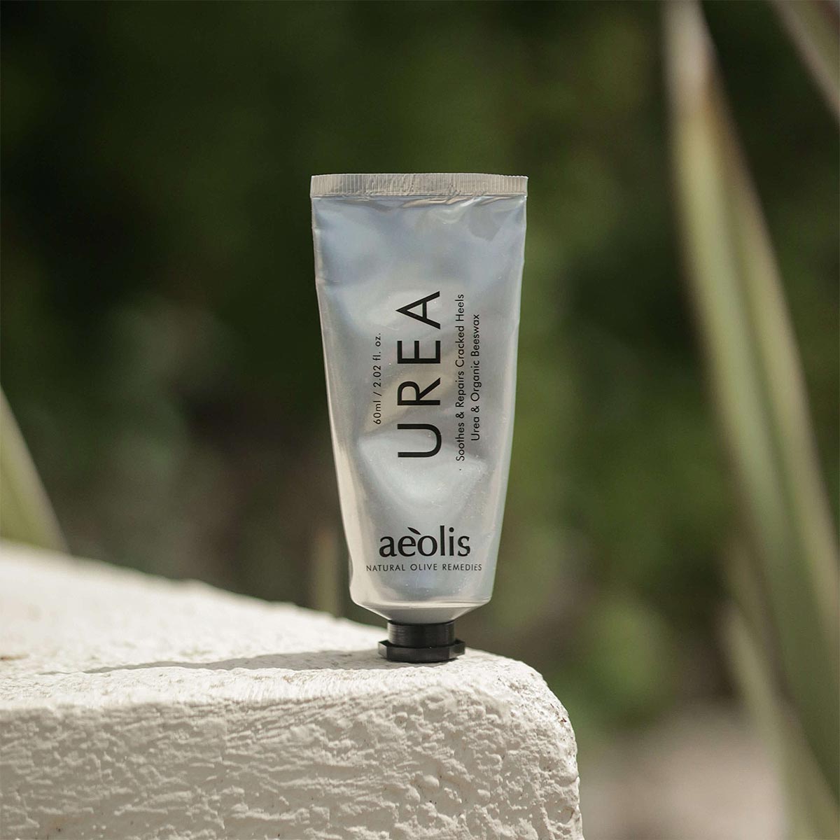 Tube of UREA foot cream by aeolis on a stone surface with a blurred natural background