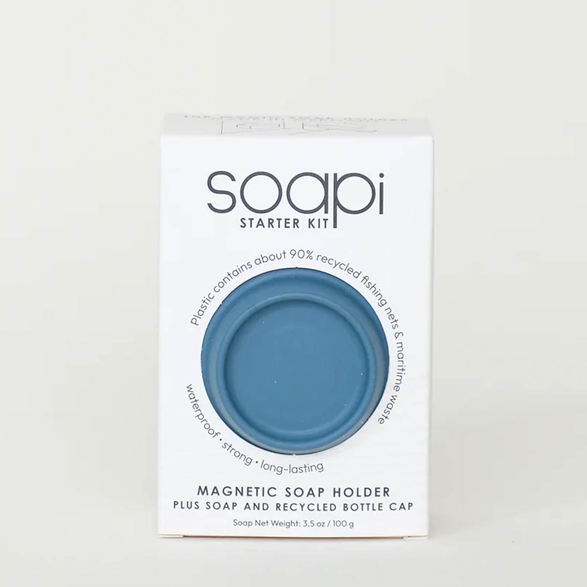 A white rectangular box labeled 'soapi Starter Kit' with a circular cutout showing a petrol blue magnetic soap holder, photographed against a plain light background.