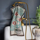 Ekelund 'Lollo' hand towel hooked onto a brass shower and bath unit in a contemporary room