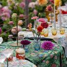 Ekelund 'Fagelliv' table runner draped over an outdoor table with desserts and colourful flowers
