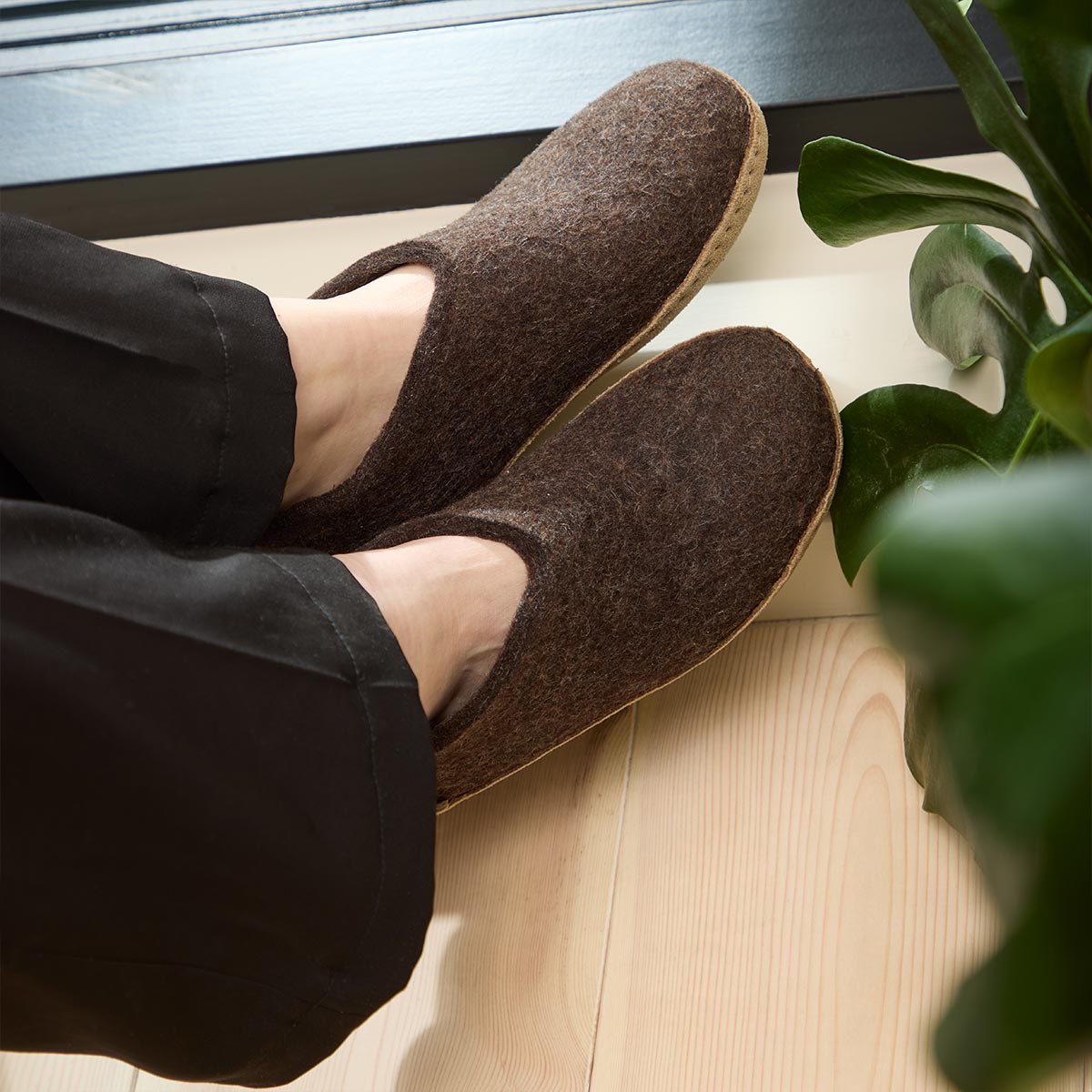 A model wears a pair of Brown Glerups Shoes with natural Leather soles
