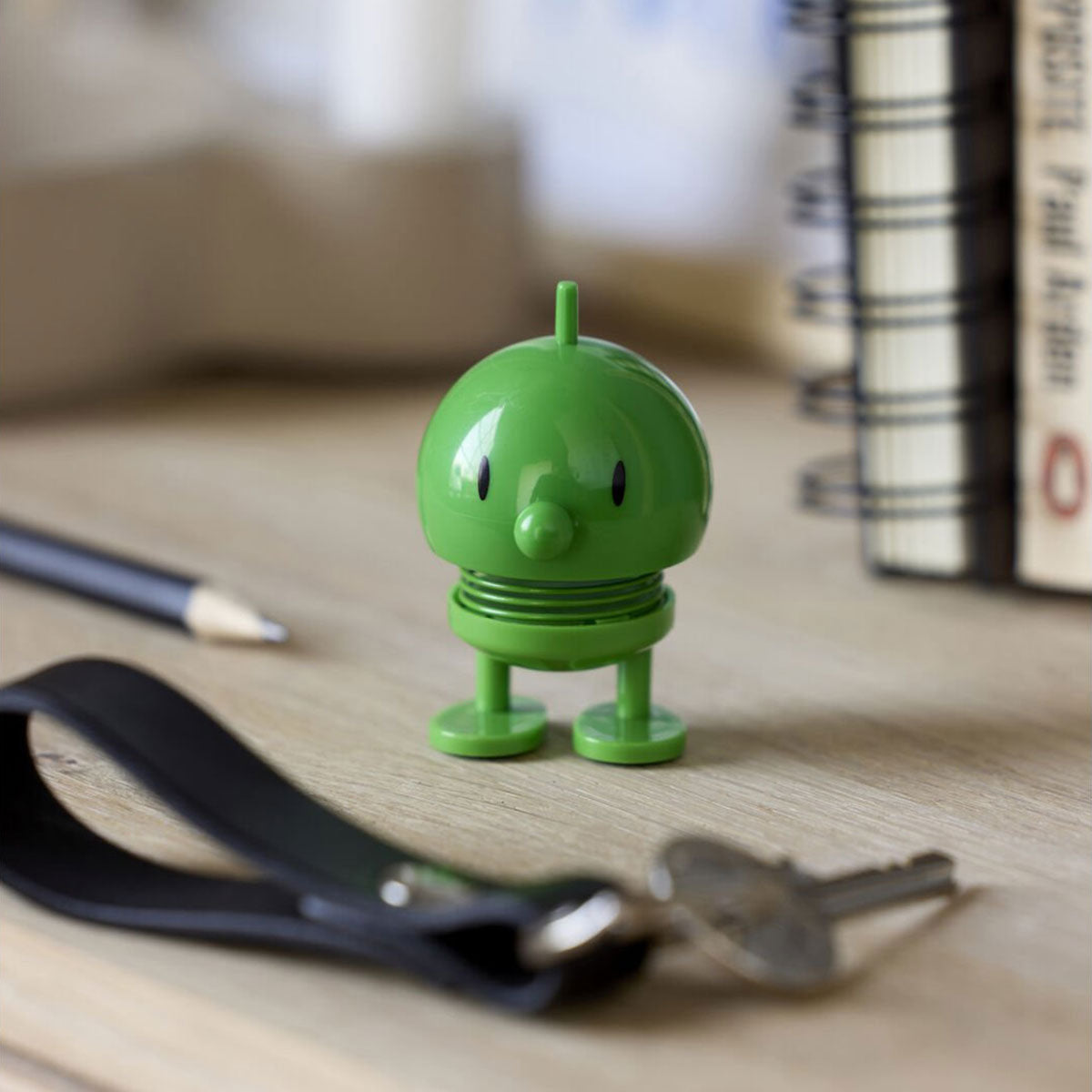 Hoptimist Mini Green Bumble on desk with ring of keys and books