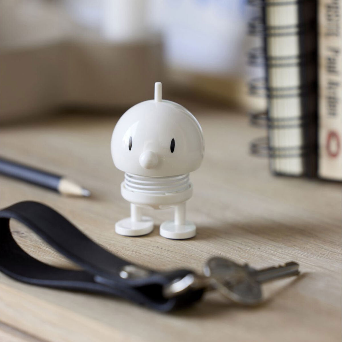 Hoptimist Mini Bumble White on desk with books and ring of keys
