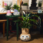 Bjorn Wiinblad Olga vases in a wooden studio with greenery inside 