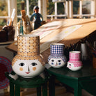 Bjorn Wiinblad Olga vases on green stools in a design workshop