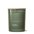 Green candle with wooden lid and 'Skandinavisk' branding on a white background