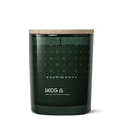 Dark green Skog candle with wooden lid featuring Skandinavisk branding on a white background