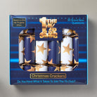 Box of Christmas crackers with star design and '1% Club' branding on a gray background