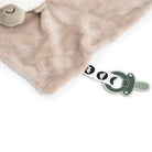 Close up of Done by Deer 'Sheepy' comfort blanket showing the pacifier attachment against a white background.