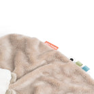 Close up of Done by Deer 'Sheepy' comfort blanket against a white background.