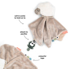 Done by Deer 'Sheepy' comfort blanket with pacifier against a white background with annotated features.