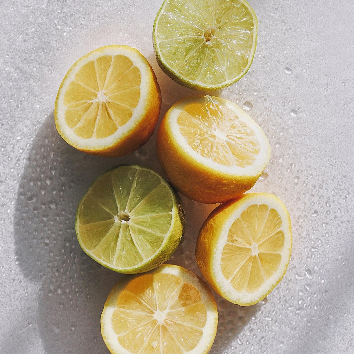 Sliced lemons and bergamots on a textured surface used in aeolis hand wash