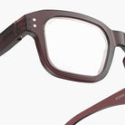 Close-up of a pair of IZIPIZI glasses with a clear lens on a white background