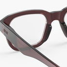 Close-up of a pair of IZIPIZI glasses with a clear lens on a white background