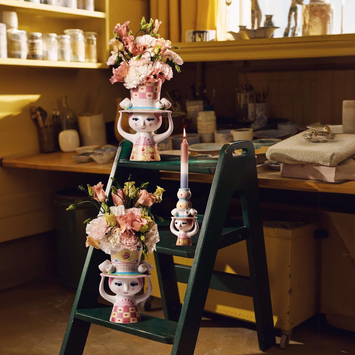 Bjorn Wiinblad Lady with hat collection in yellow and pink on a green stepladder