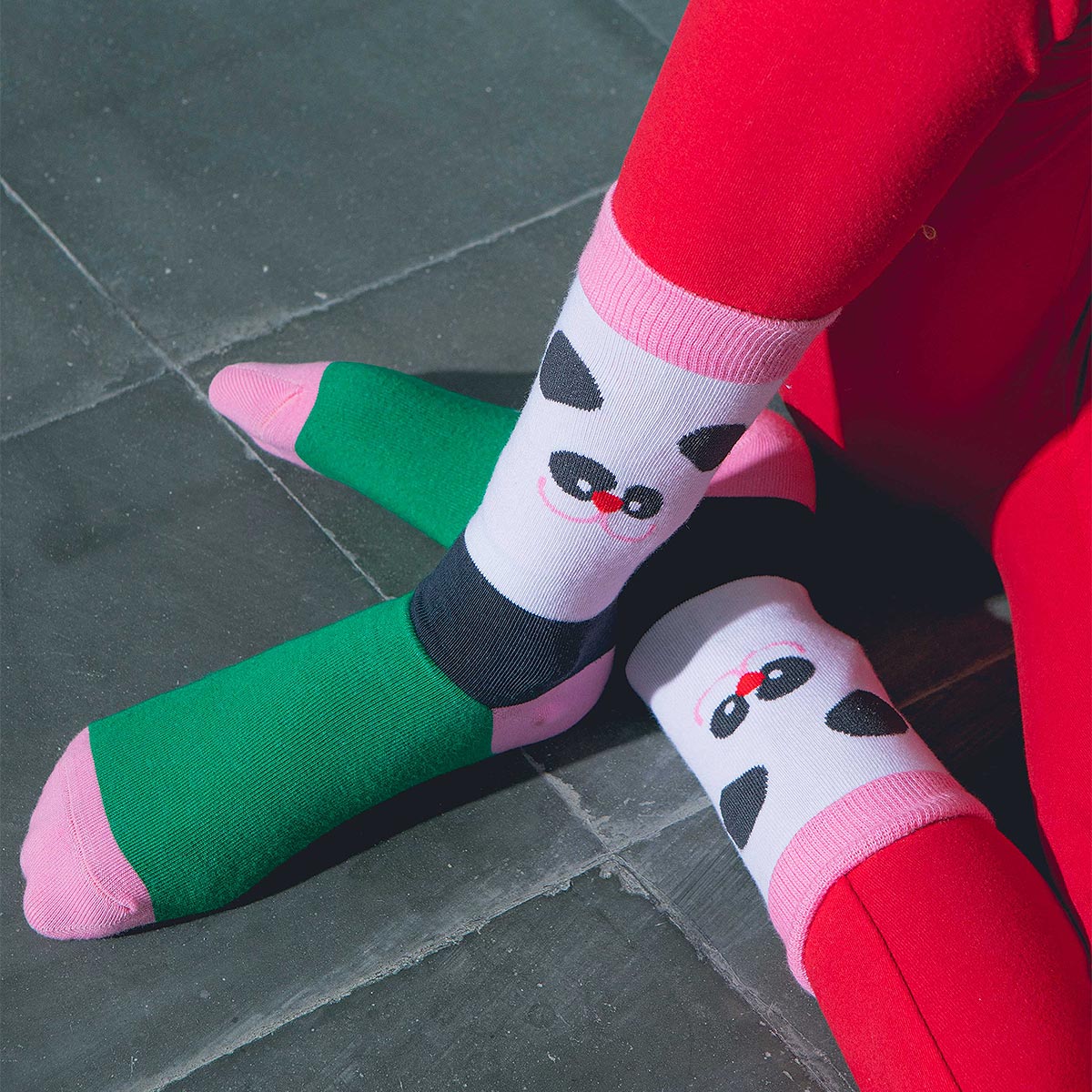 A child wearing colourful Eat MySocks Lazy Panda socks.
