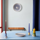 Bjorn Wiinblad Olga Canlde Collection on a blue table with Olga bowl and wall decoration