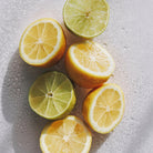 Sliced bergamots and limes on a wet surface used in aeolis shower gel