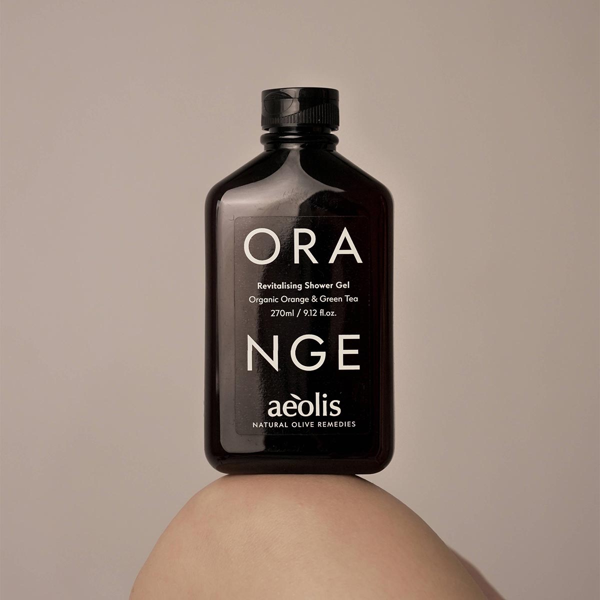 Brown bottle of Orange shower gel by aeolis on a beige background