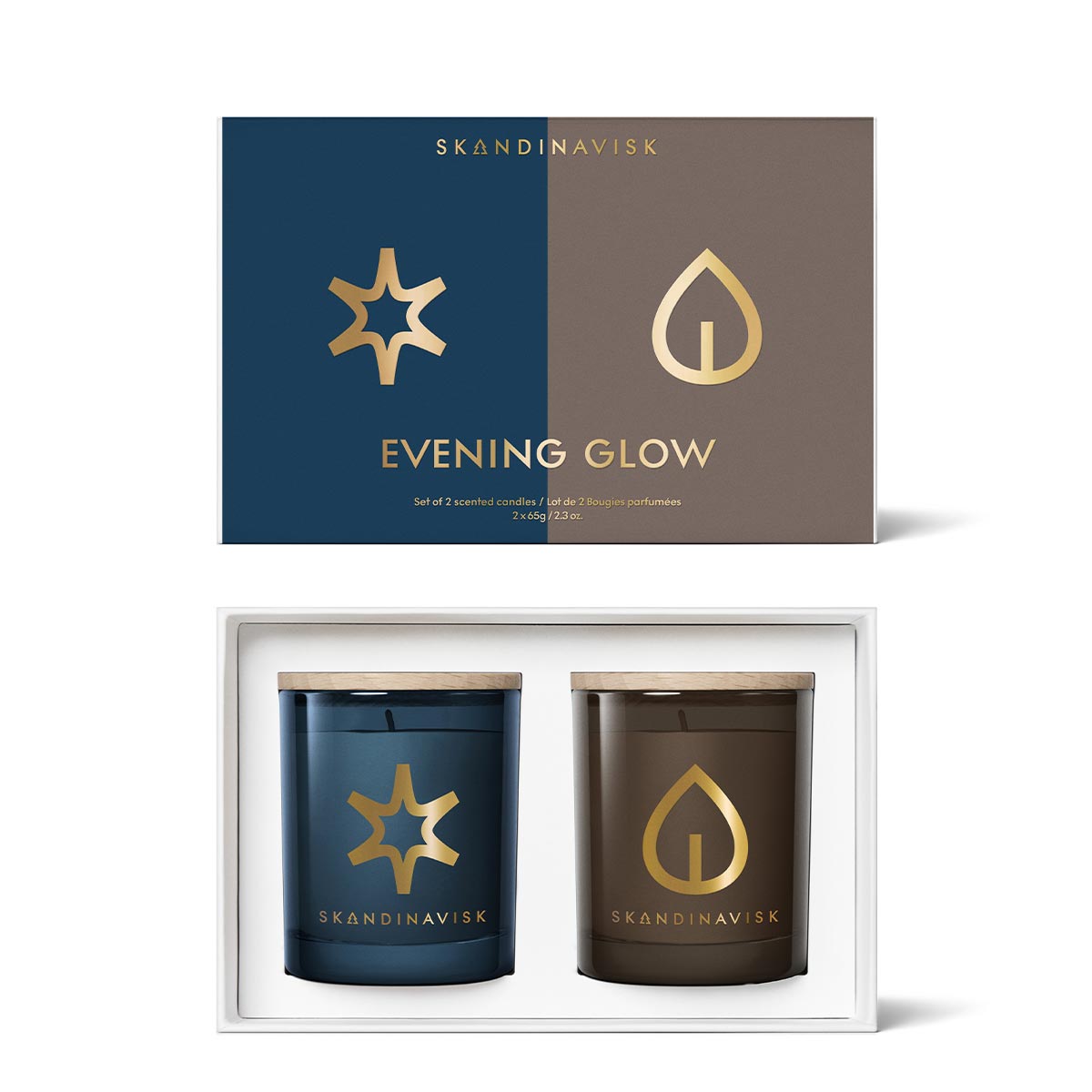 Skandinavisk Evening Glow candle gift set with two soy candles in a white tray below the product box, featuring a navy blue and brown color-blocked design with gold logos and text.
